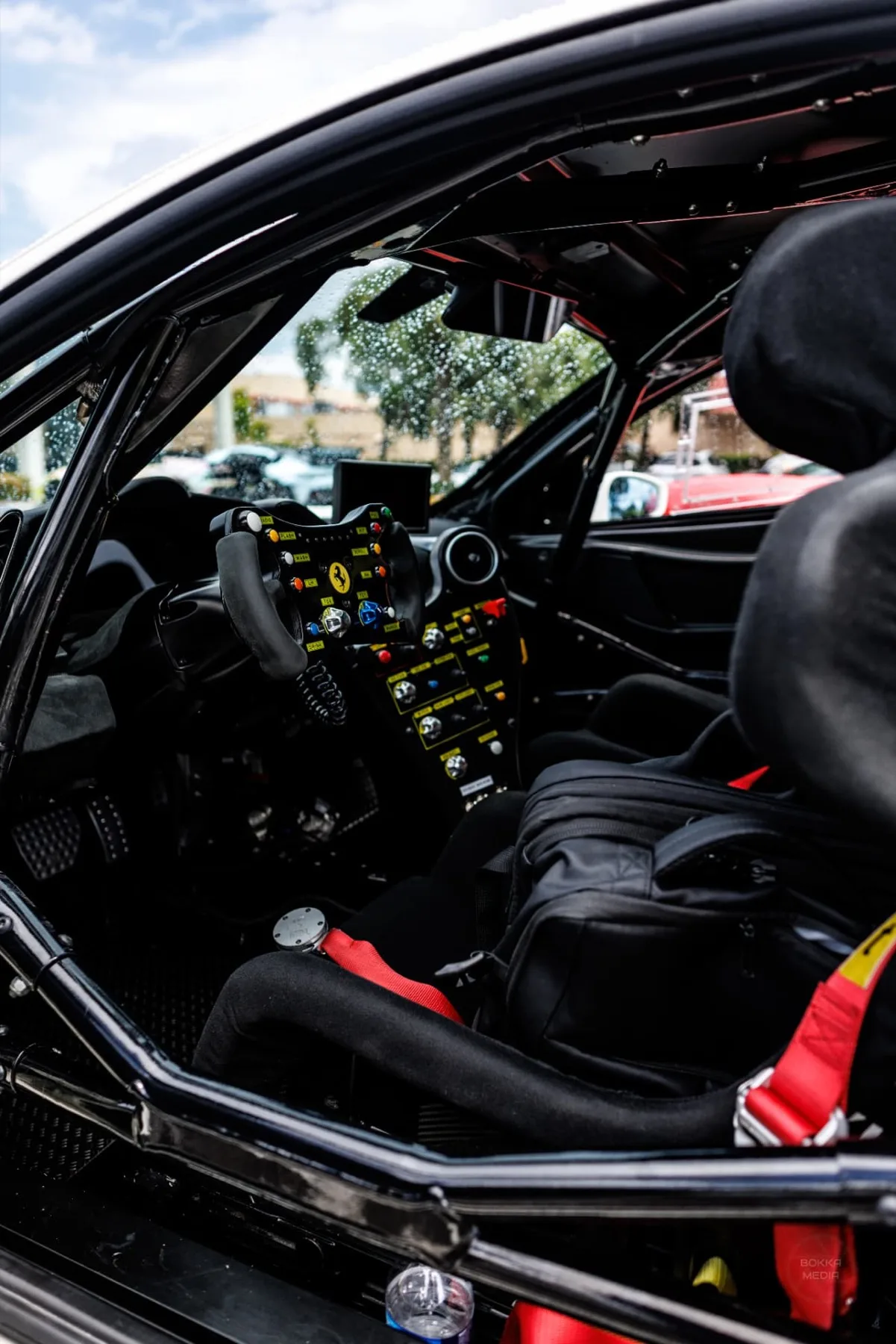 Race-spec Ferrari cockpit with roll cage and multifunction steering wheel