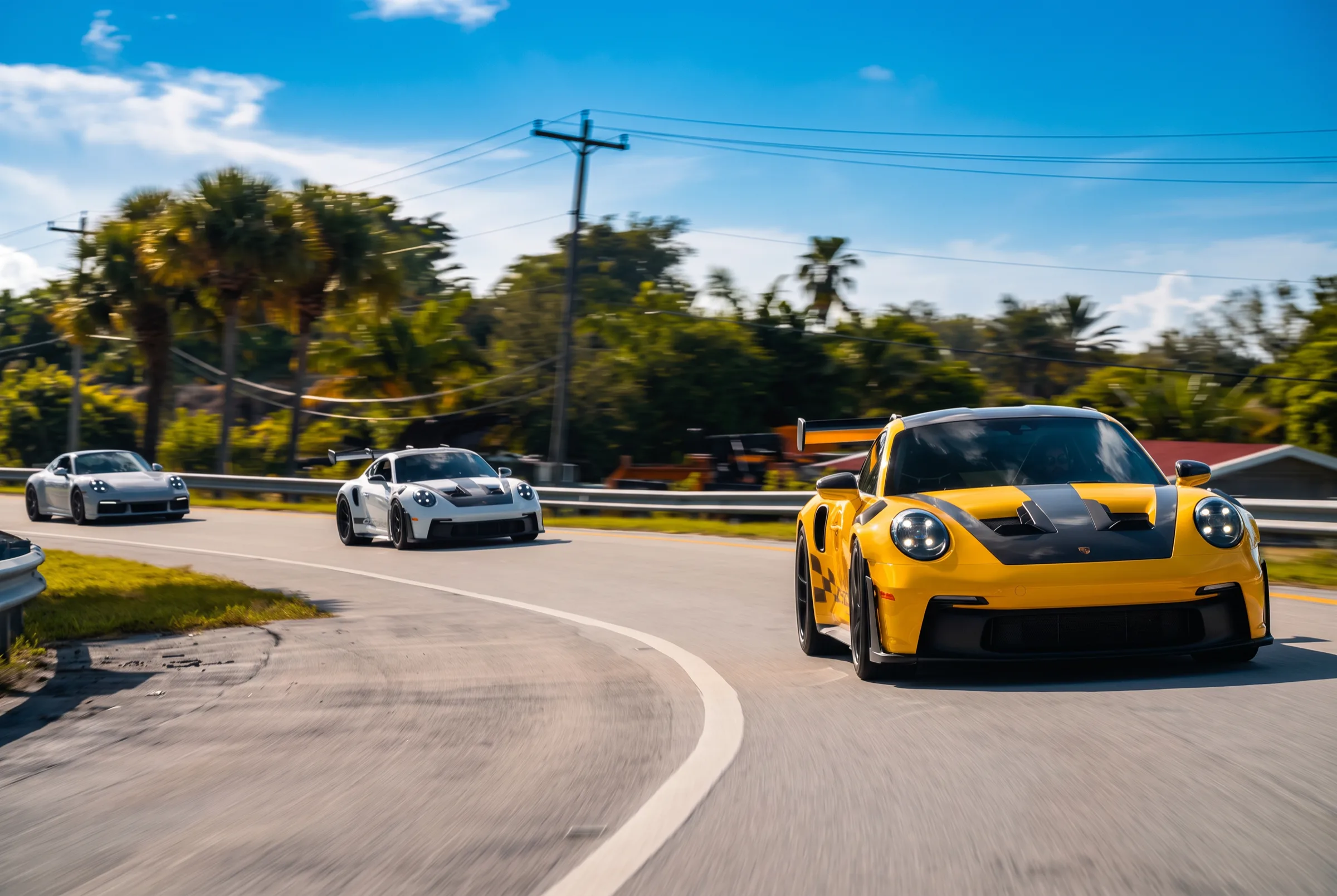 A Porsche GT3 RS leading through a sweeping curve