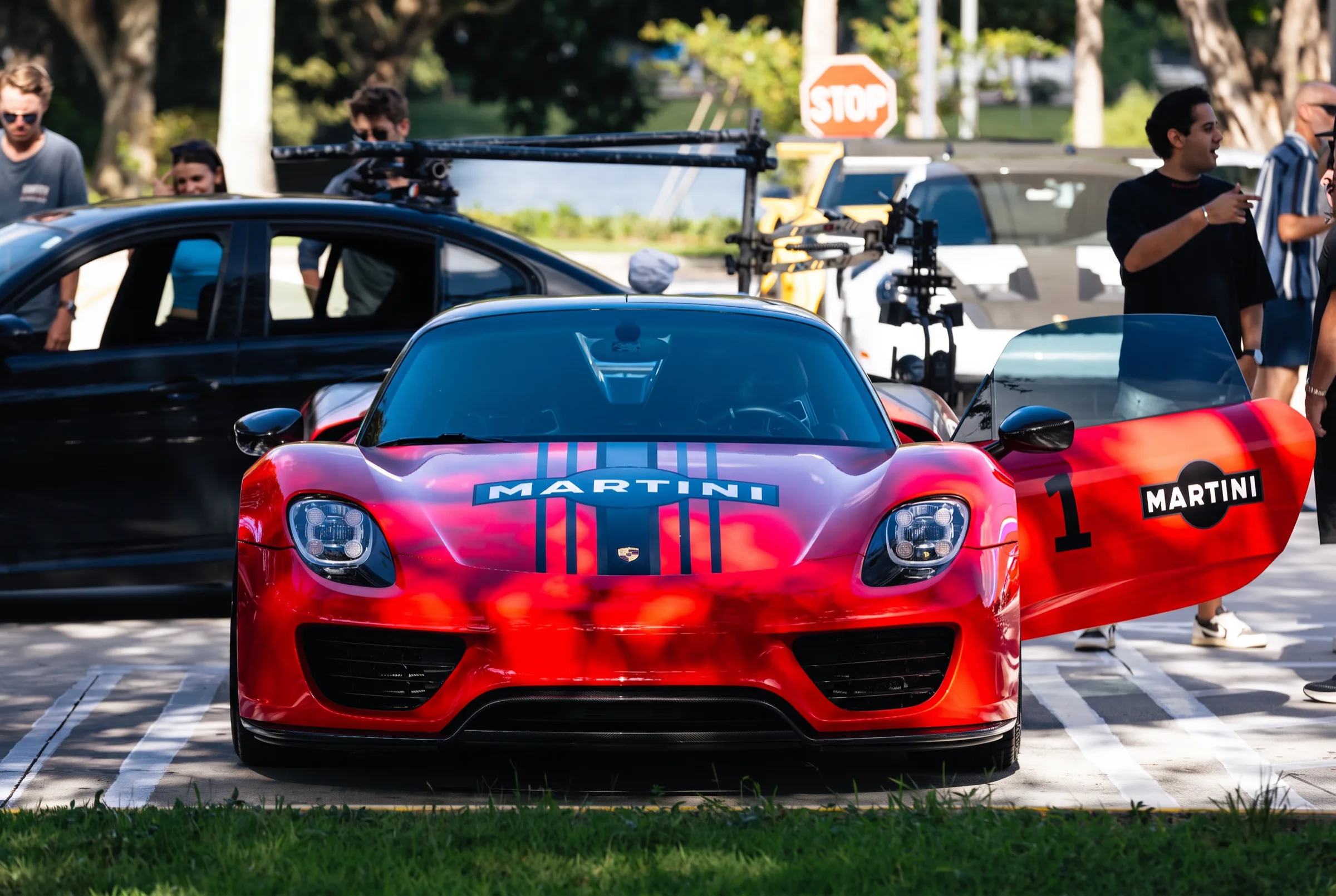 The Martini-liveried Porsche 918 staged with the media unit before departure