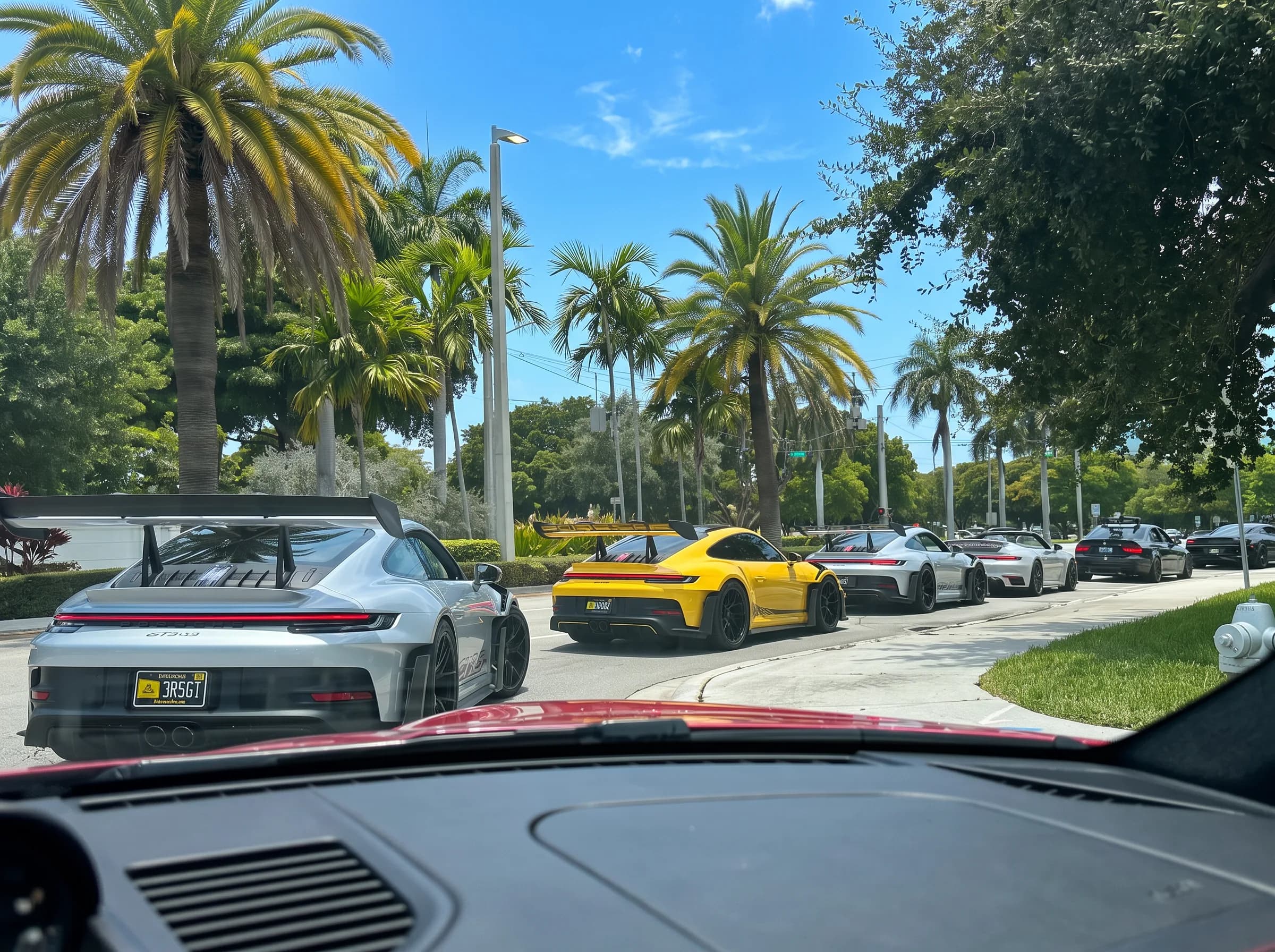 A varied lineup of supercars staged together before the convoy departs