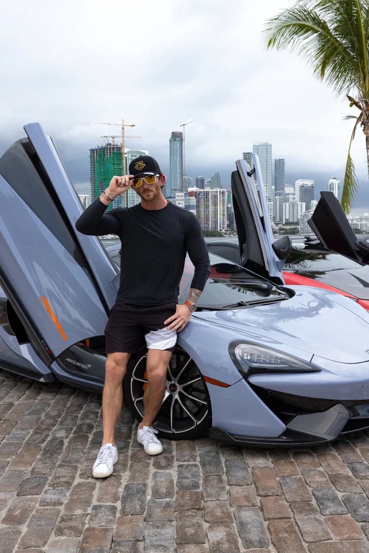 Dakota Heuer leaning against his gunmetal grey McLaren 570.