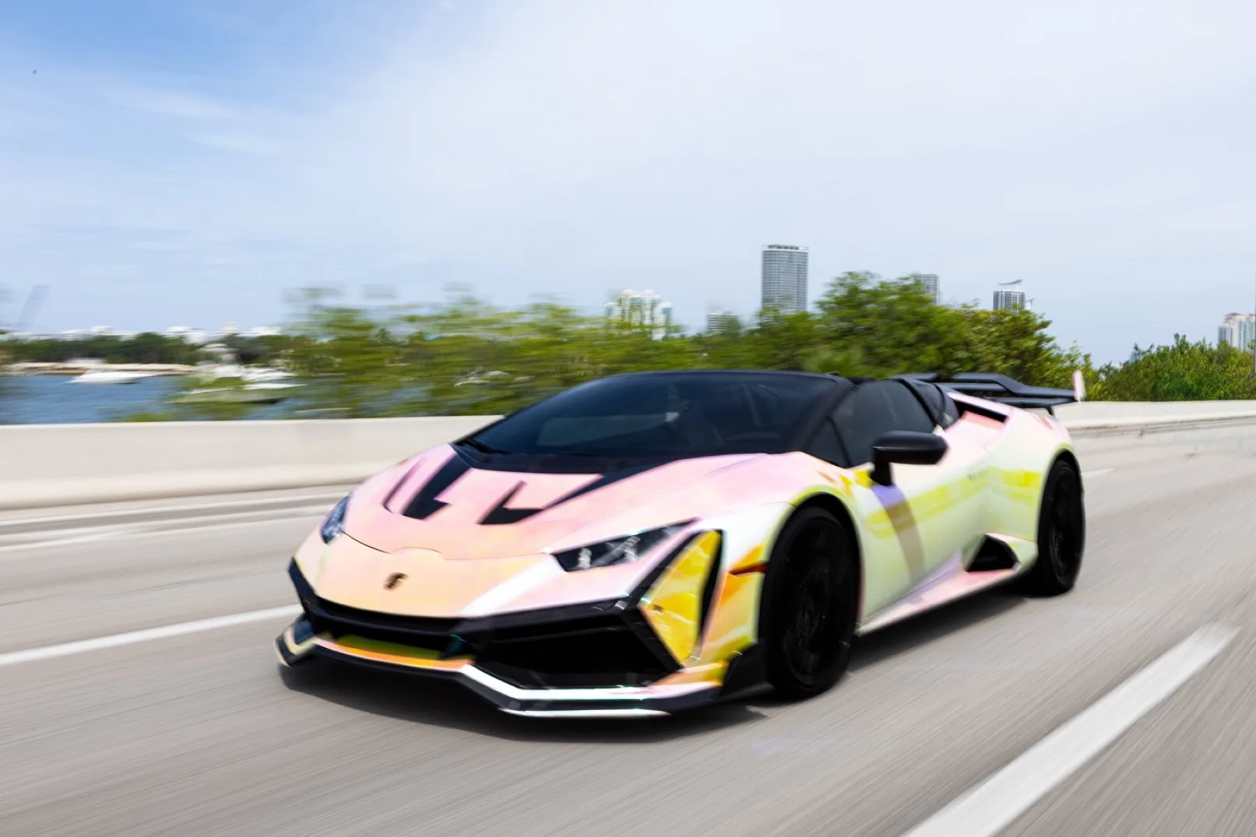 A colour-shifting Lamborghini Huracán on the highway.