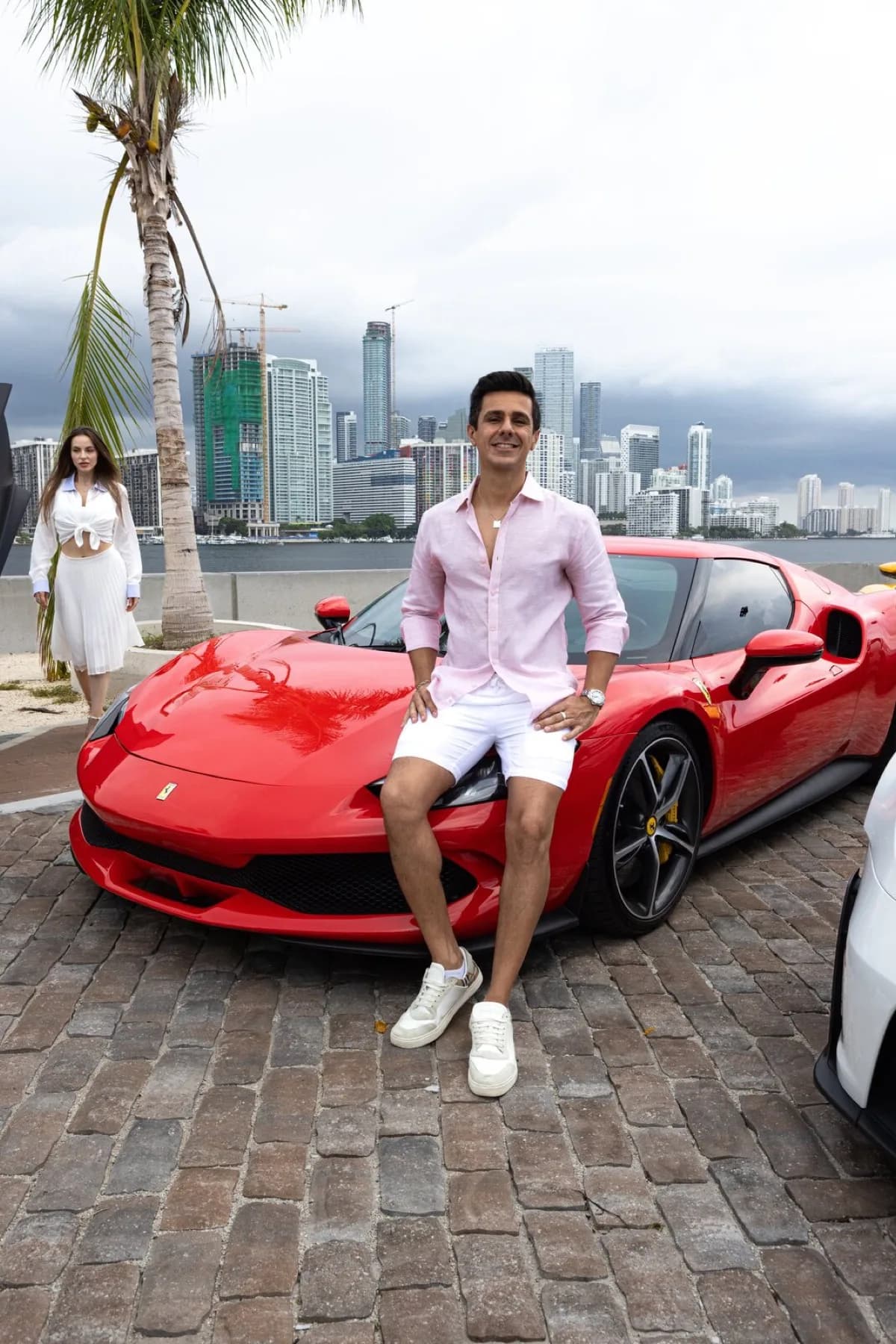 Samir Machado seated on the front of his Rosso Corsa Ferrari 296.
